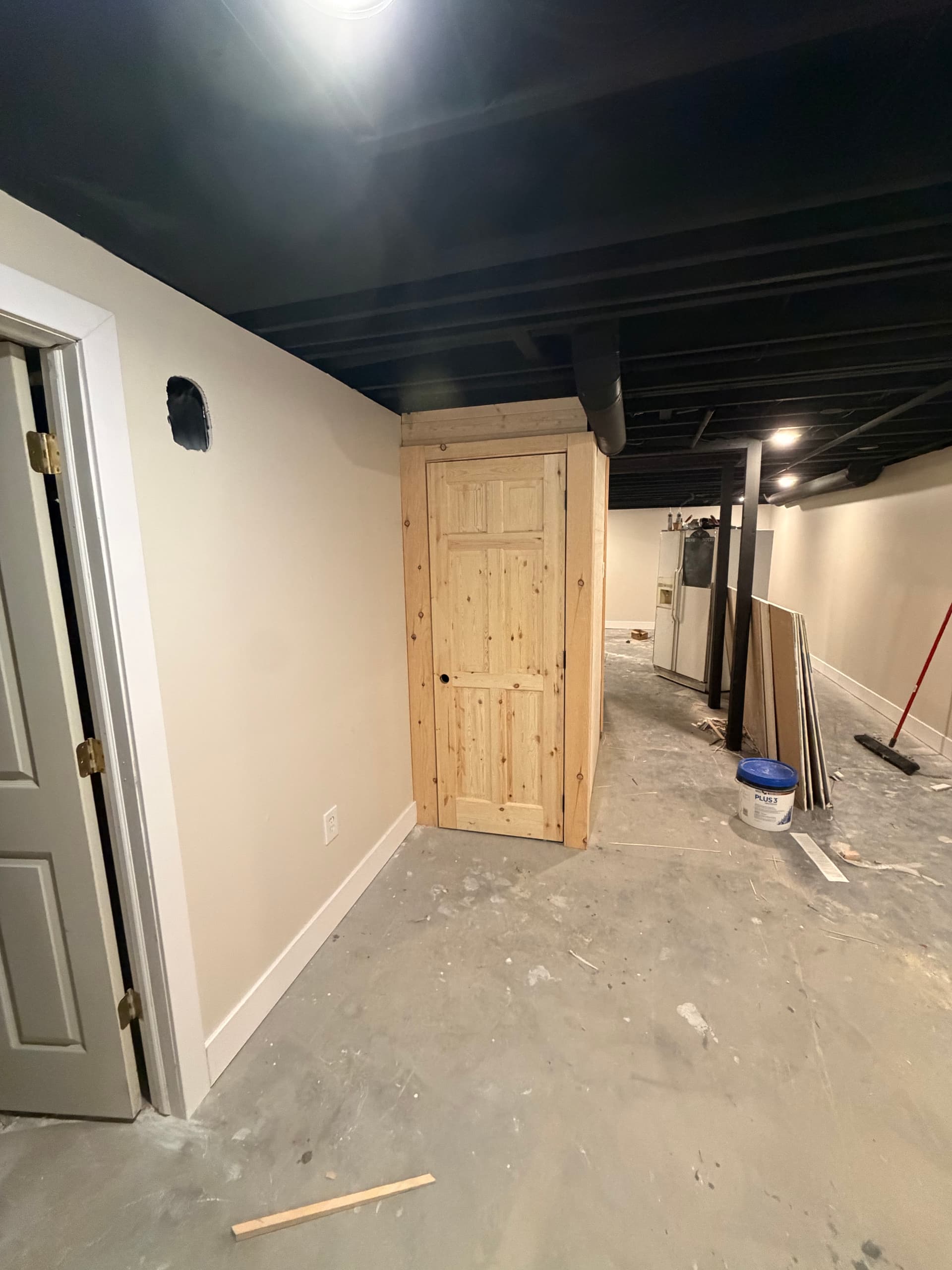 Custom Under-Stair Storage Built Into a Basement Remodel image